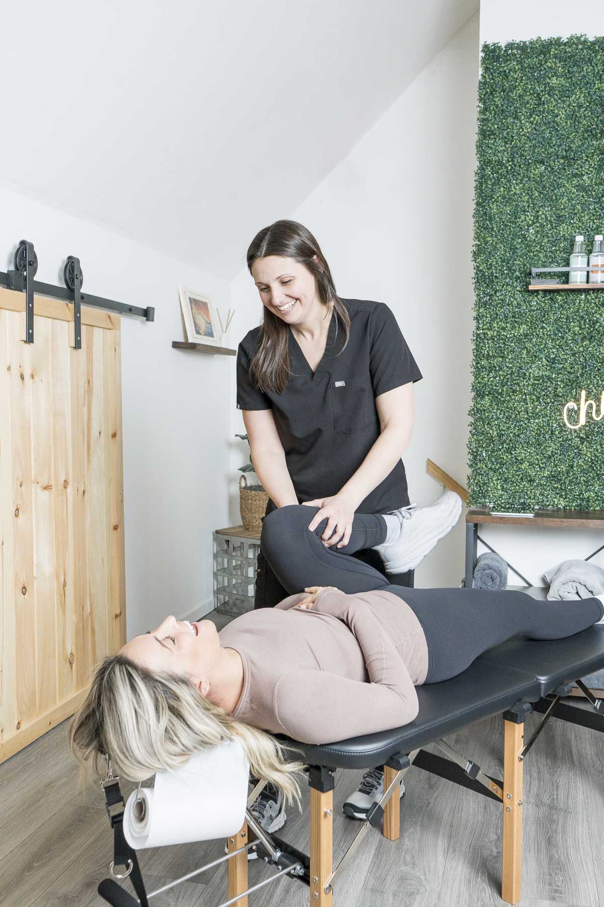 Dr. Abby Dante stretching a patient's leg on a treatment table