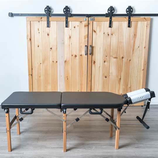 Treatment table in front of a sliding barn door